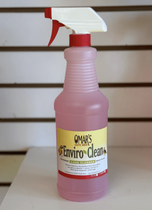 A pink bottle of Omar's Enviro-Clean cage cleaner.
